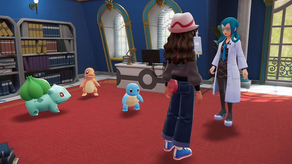 The player character speaks with a researcher (Professor Mable) inside a lab, with Bulbasaur, Charmander, and Squirtle (the Kanto starter Pokémon) lined up on the floor ready to be chosen.