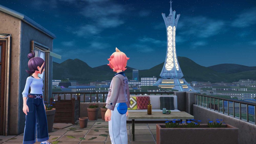 The player character (with pink hair) and an NPC companion stand on a rooftop at night, gazing out at Lumiose City’s skyline dominated by the illuminated Prism Tower.